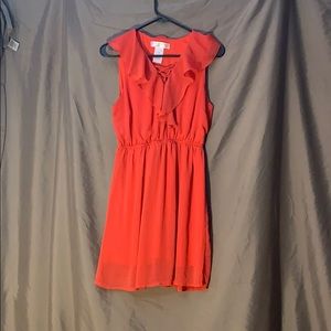 Coral colored mini dress, with ruffles.